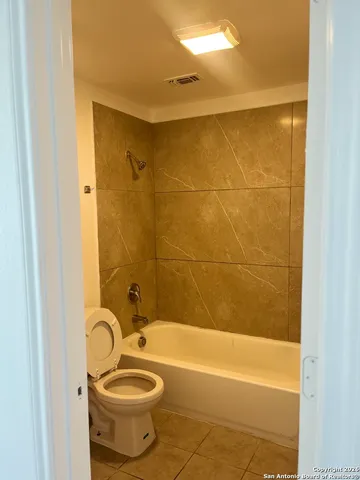 a bathroom with a shower and a sink