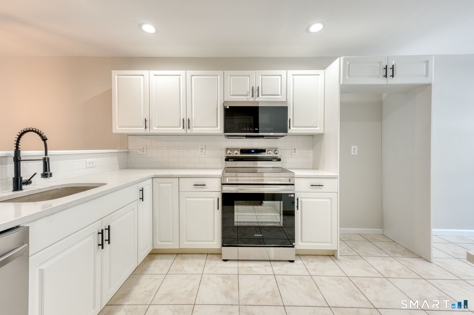 159 Jennifer Lane, Unit 159 Newtown, CT 06482 - Photo 12 of 28 a kitchen with cabinets appliances and a sink