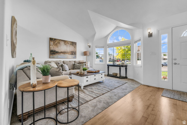 1147 West State Road Lehi, UT 84043 - Photo 4 of 31 Living area featuring vaulted ceilings and a large arched window