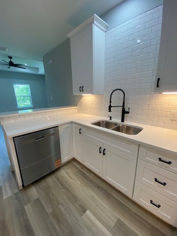 116 Field Street Luling, TX 78648 - Photo 7 of 33 Gleaming white cabinetry and stainless steel appliances complete this bright, contemporary kitchen.