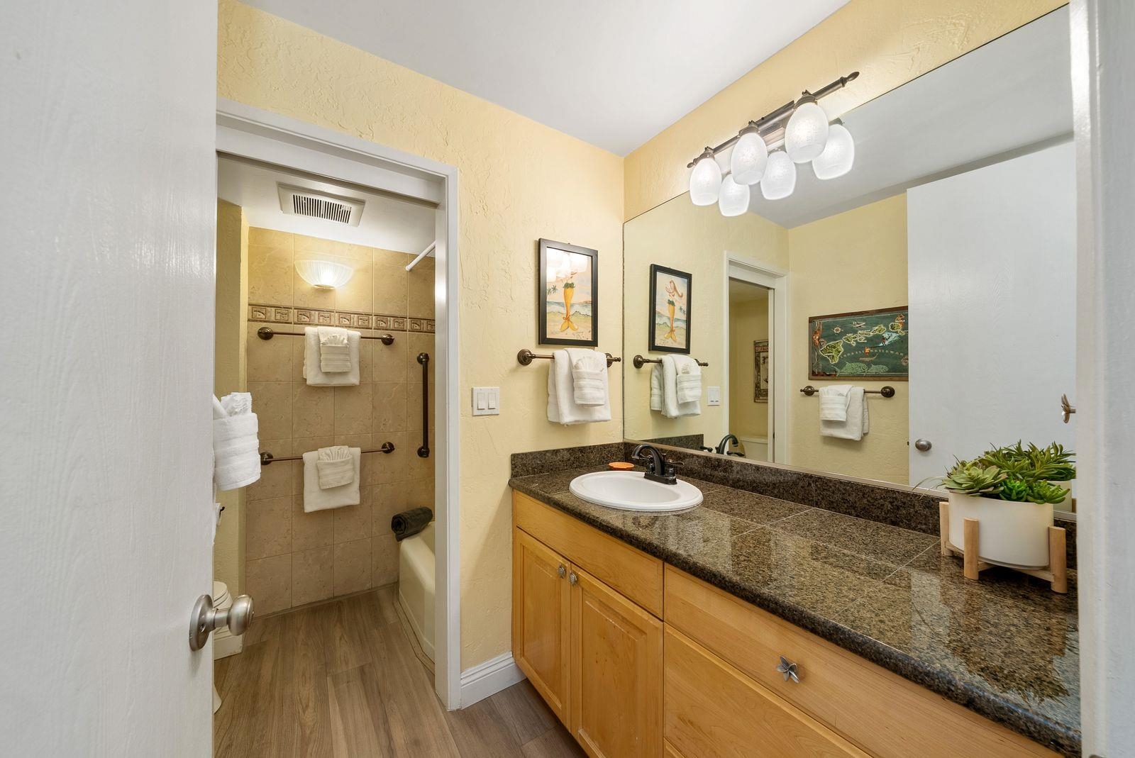 3543 Lower Honoapiilani Road, Unit J401 Lahaina, HI 96761 - Photo 11 of 25 a spacious bathroom with a granite countertop sink a mirror and a shower