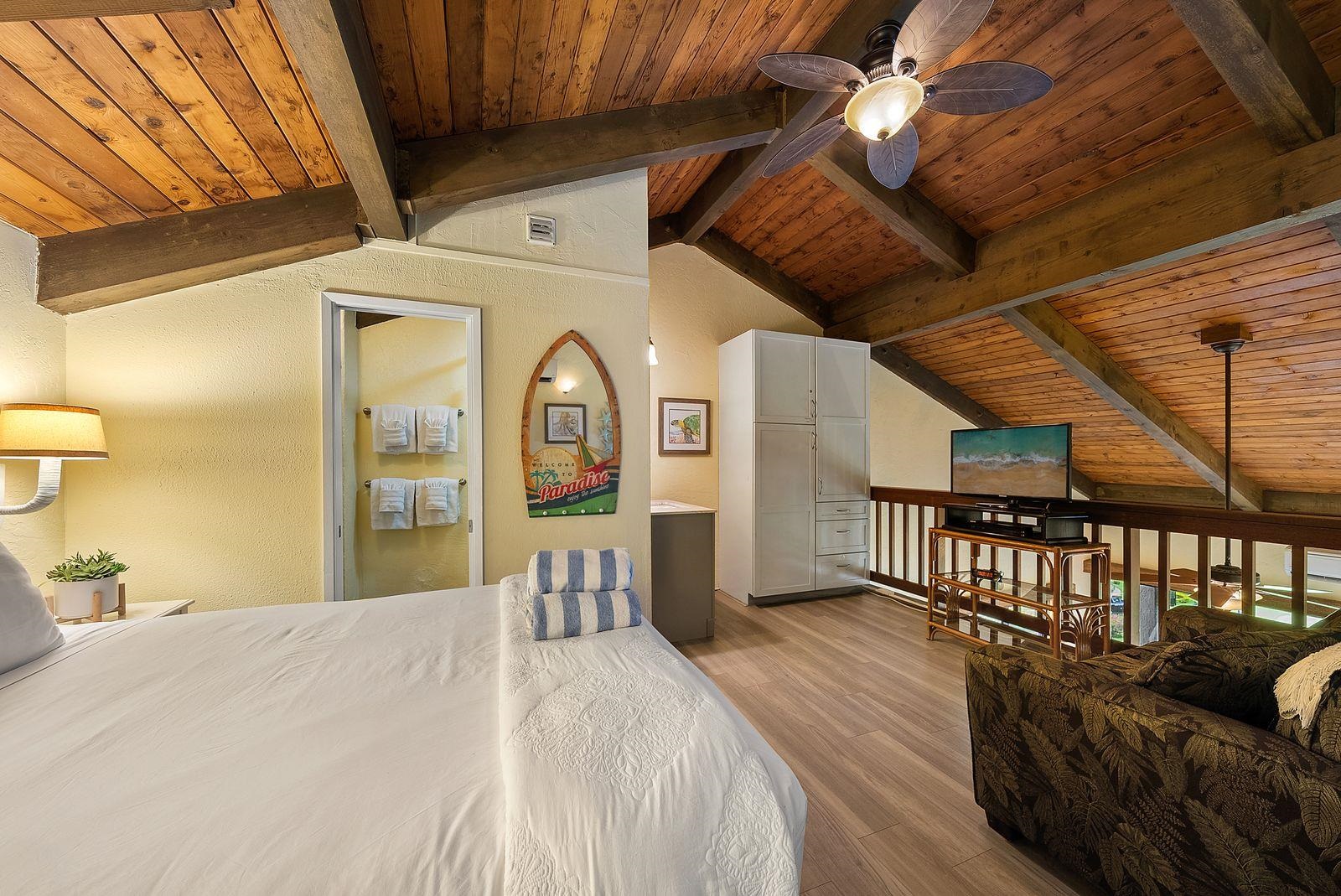 3543 Lower Honoapiilani Road, Unit J401 Lahaina, HI 96761 - Photo 14 of 25 a bedroom with furniture and a large window