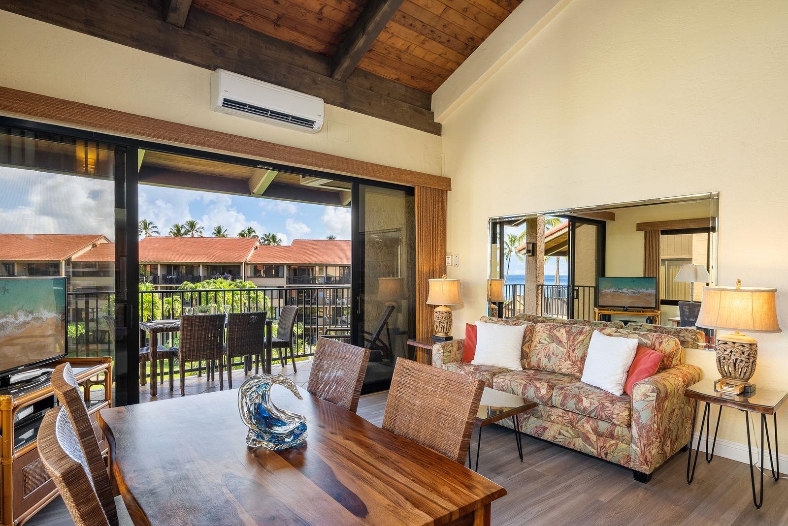 3543 Lower Honoapiilani Road, Unit J401 Lahaina, HI 96761 - Photo 5 of 25 a living room with furniture and a large window