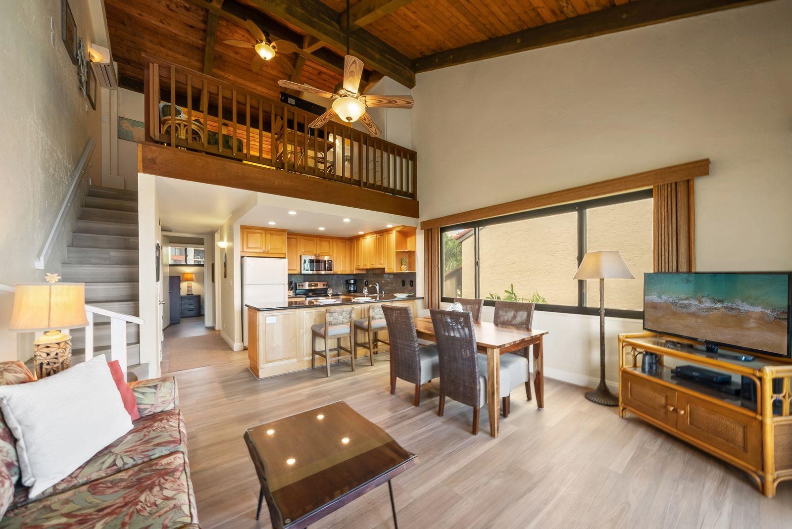 3543 Lower Honoapiilani Road, Unit J401 Lahaina, HI 96761 - Photo 6 of 25 a living room with furniture and a floor to ceiling window