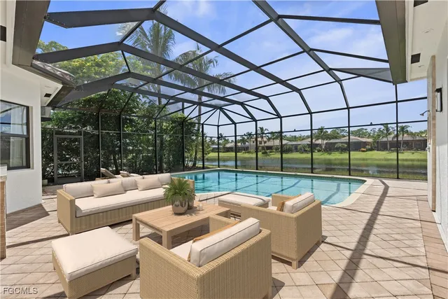 a roof deck with couch and chairs