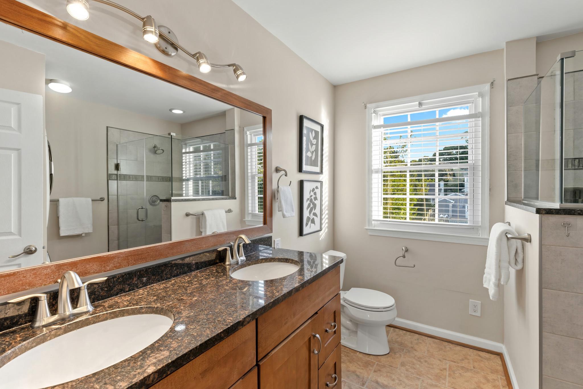 310 Magothy Road Severna Park, MD 21146 - Photo 16 of 38 a bathroom with a granite countertop sink toilet and a mirror