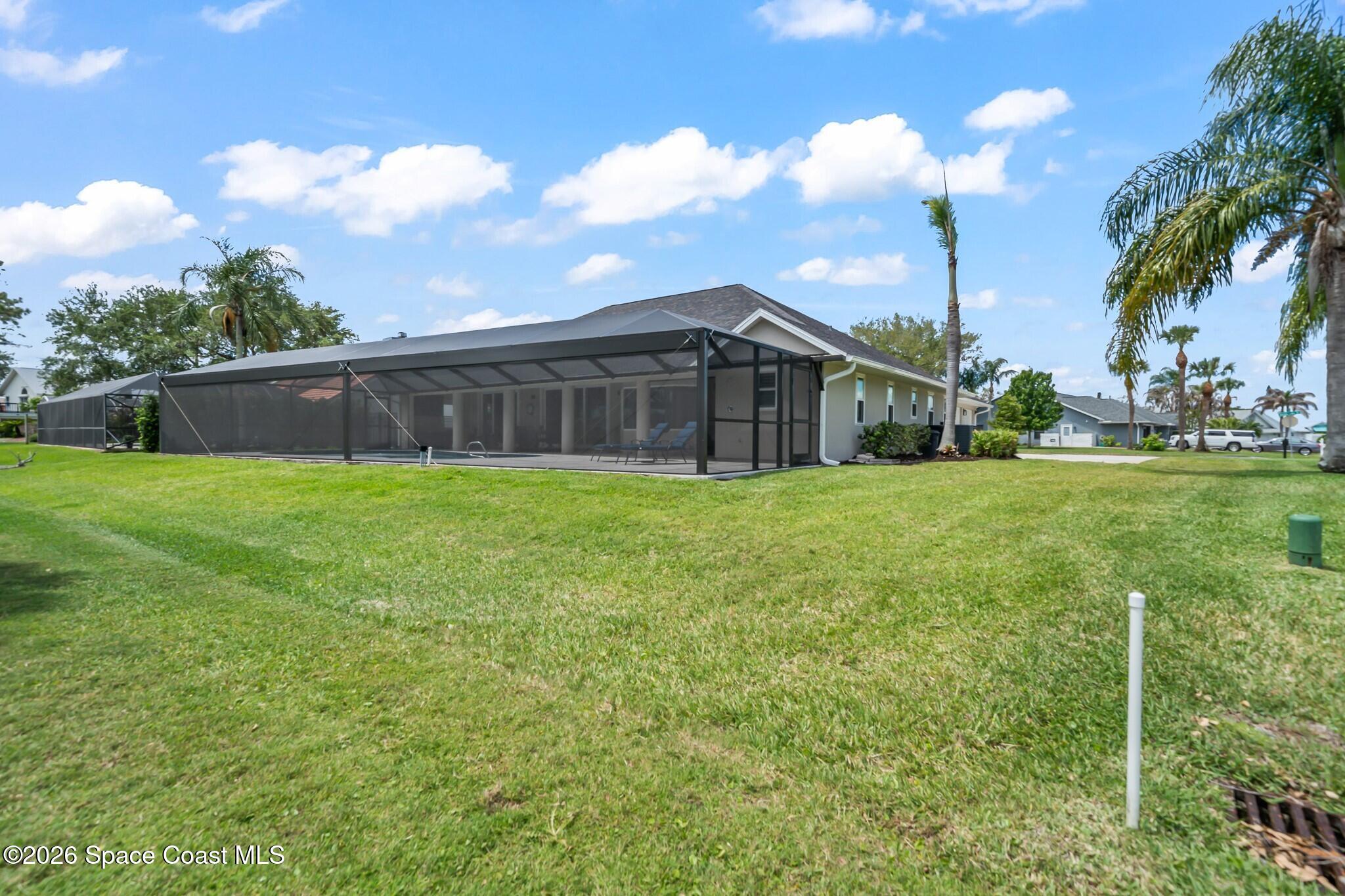 697 Spring Lake Drive Melbourne, FL 32940 - Photo 36 of 45 a view of a house with a yard and sitting area