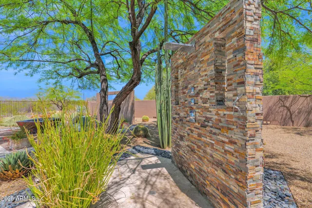 a bedroom with a bed chandelier and a window