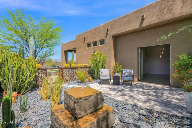a bathroom with a granite countertop toilet sink and mirror