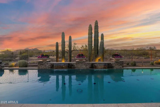 an aerial view of a house with a yard and lake view