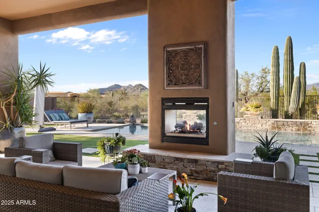 a kitchen with stainless steel appliances granite countertop a stove a sink a oven a dining table and chairs