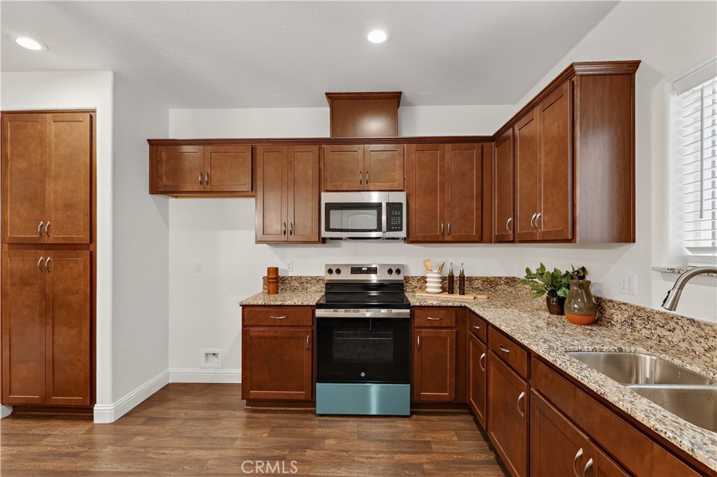 236 Montage Drive Merced, CA 95348 - Photo 10 of 36 a kitchen with stainless steel appliances a stove a sink a microwave a refrigerator and cabinets