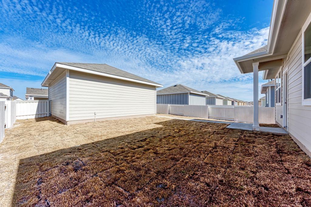 1209 Goforth Road Kyle, TX 78640 - Photo 28 of 32 A private yard with newly laid sod provides a blank canvas for outdoor living.