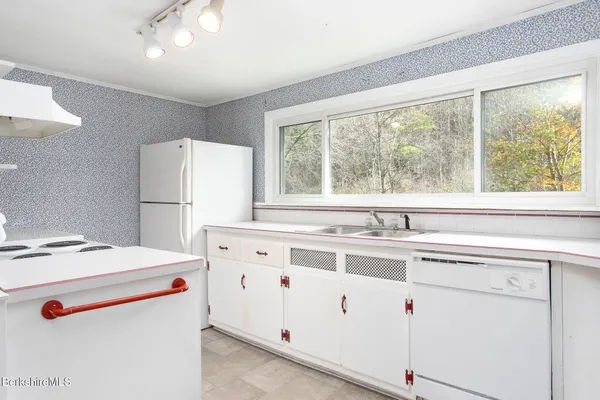 a white refrigerator freezer sitting inside of a kitchen