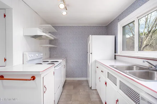 a kitchen with a sink stove and refrigerator