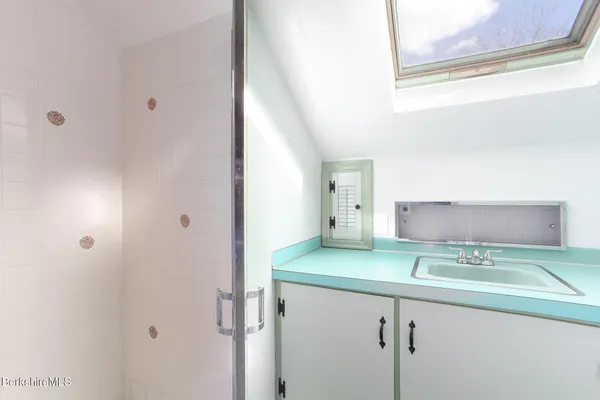 a bathroom with a sink and mirror