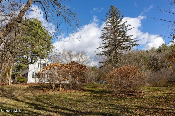 a view of a yard with large trees