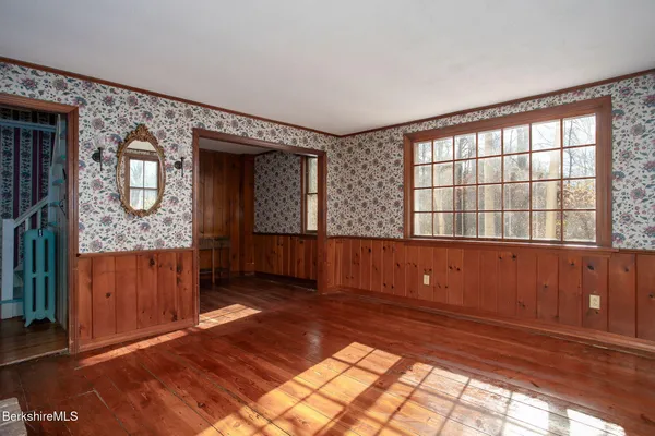 a view of entryway with a window and wooden floor