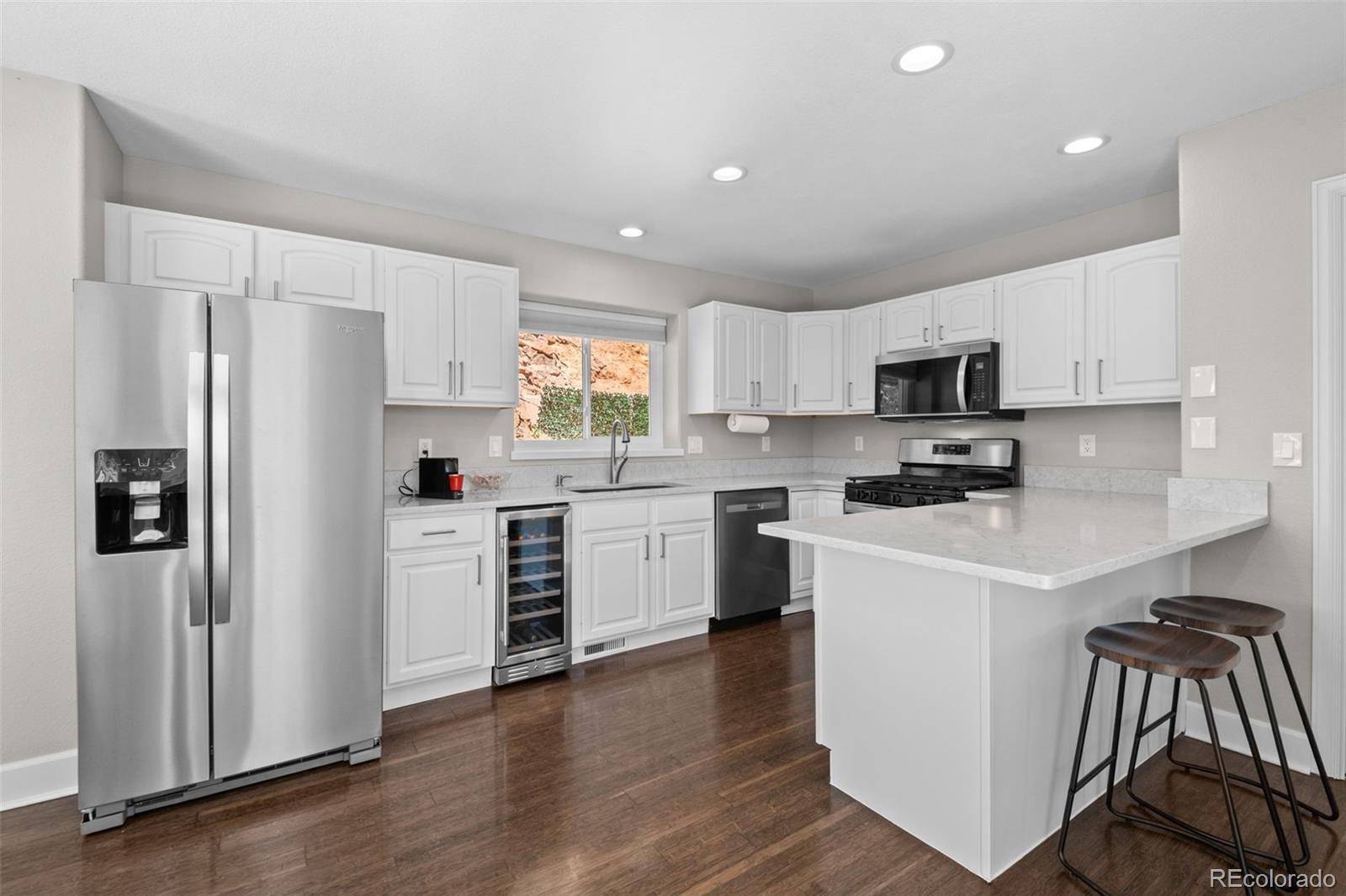 33633 Elk Run Evergreen, CO 80439 - Photo 11 of 39 a kitchen with white cabinets and stainless steel appliances