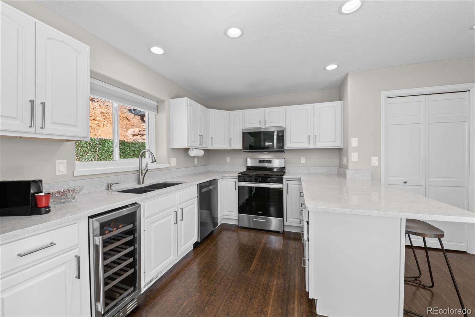 33633 Elk Run Evergreen, CO 80439 - Photo 12 of 39 a kitchen with white cabinets and appliances