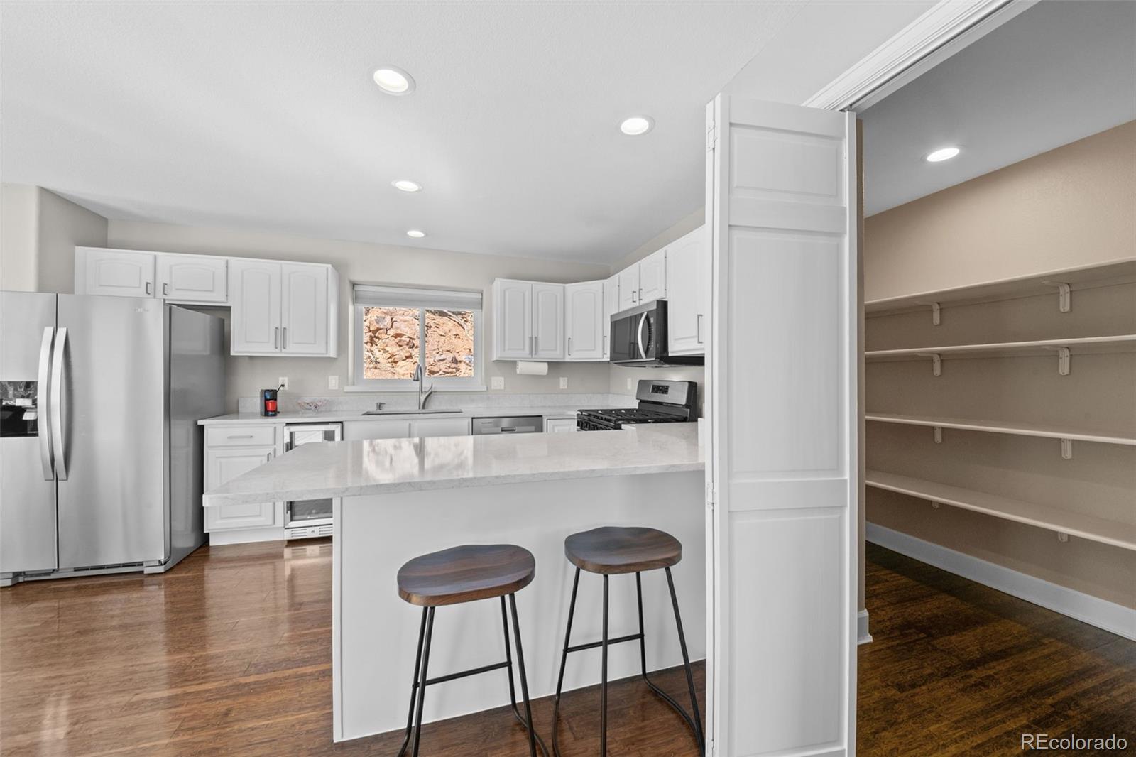 33633 Elk Run Evergreen, CO 80439 - Photo 13 of 39 a kitchen with stainless steel appliances a refrigerator and microwave