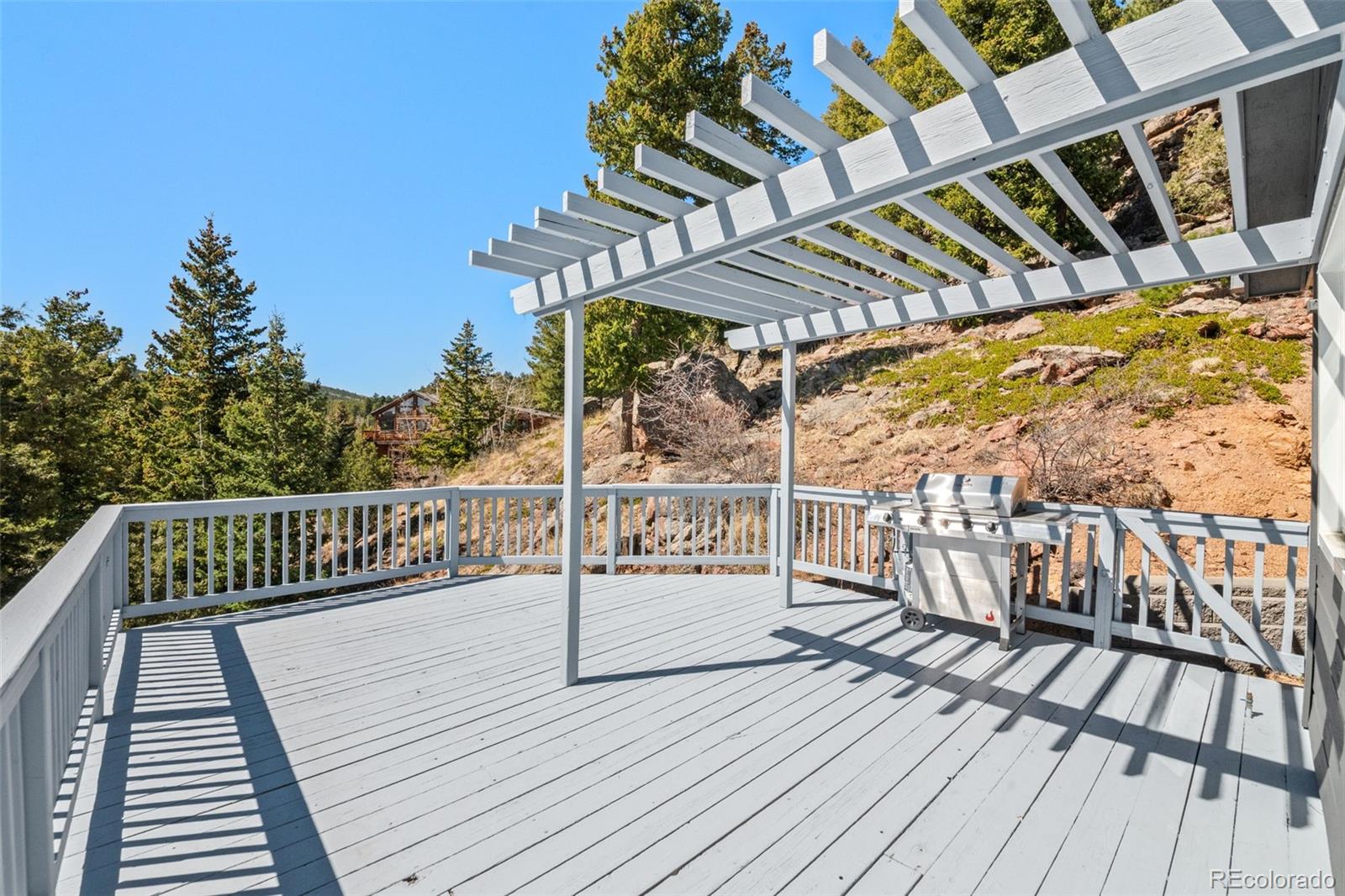 33633 Elk Run Evergreen, CO 80439 - Photo 18 of 39 a view of balcony with wooden floor and outdoor seating