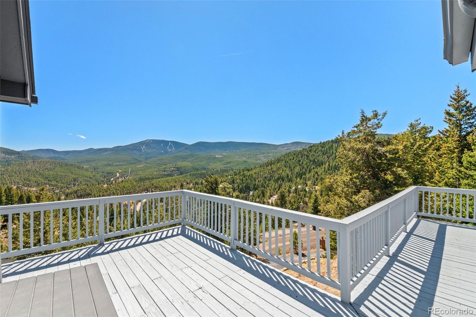 33633 Elk Run Evergreen, CO 80439 - Photo 2 of 39 a view of balcony with wooden floor and fence