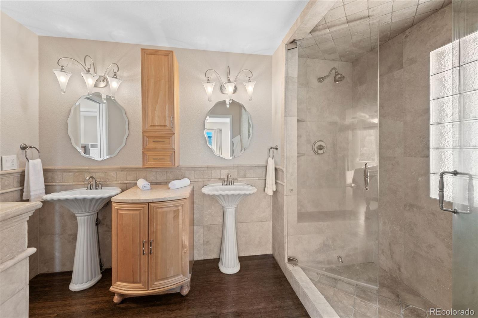 33633 Elk Run Evergreen, CO 80439 - Photo 22 of 39 a bathroom with a double vanity sink mirror and shower