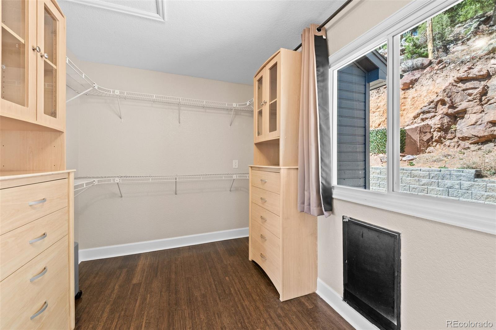 33633 Elk Run Evergreen, CO 80439 - Photo 23 of 39 a view of walk in closet with wooden floor