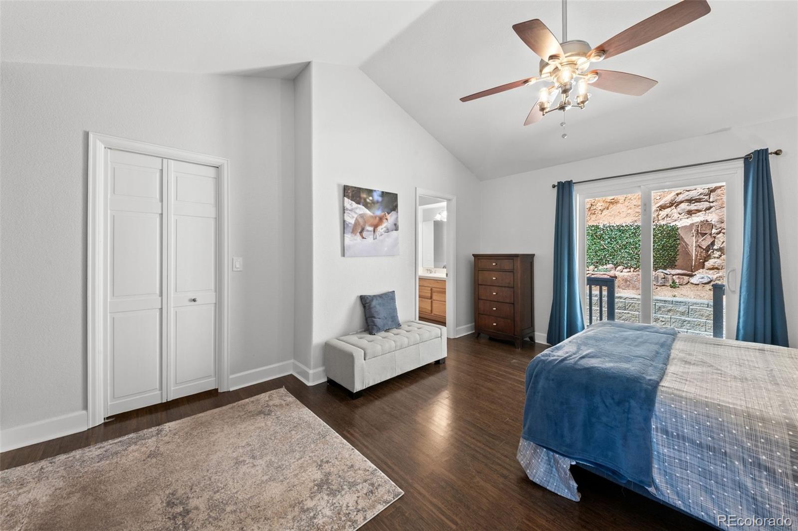 33633 Elk Run Evergreen, CO 80439 - Photo 24 of 39 a bedroom with a bed chandelier and a window