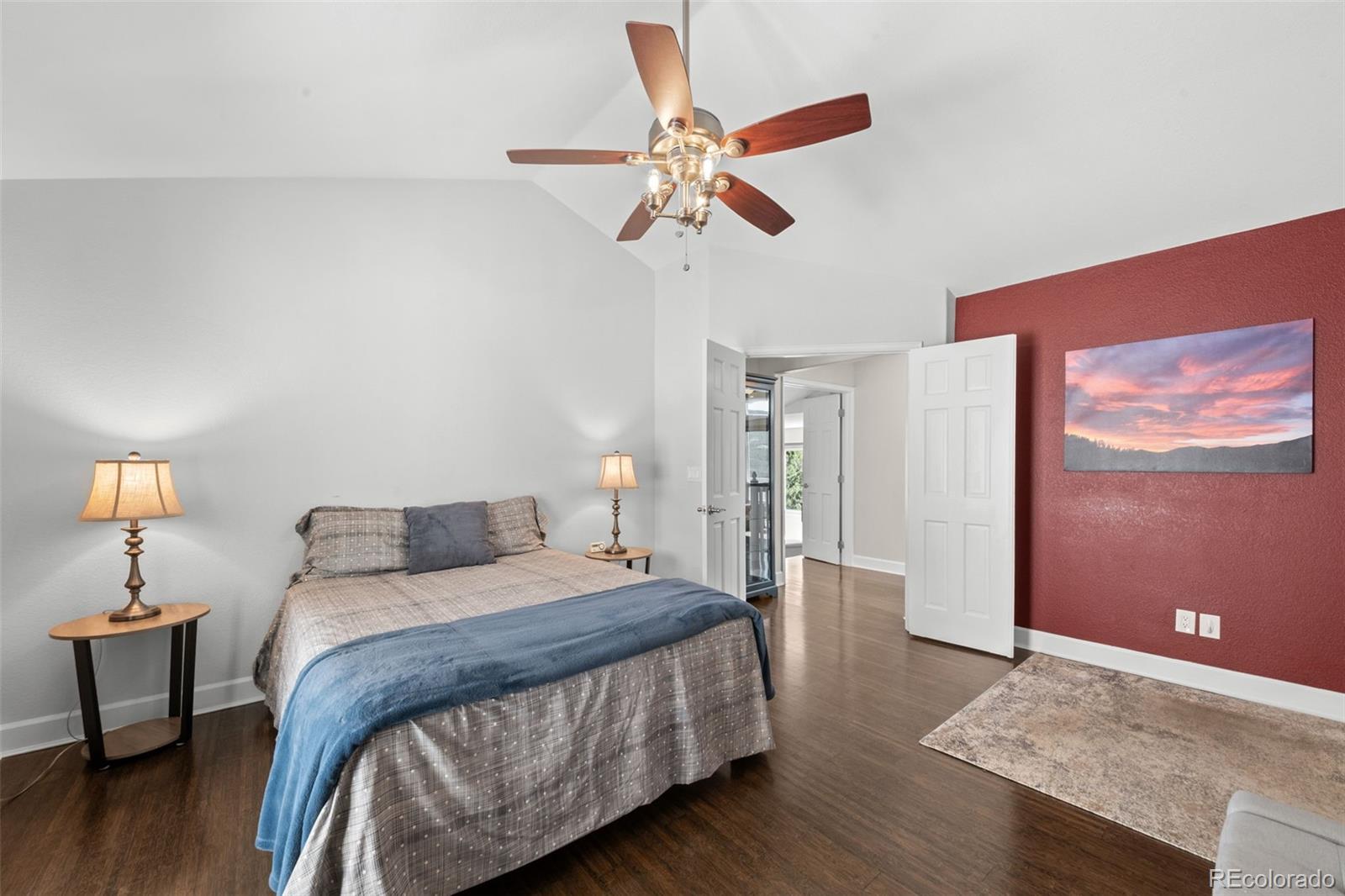 33633 Elk Run Evergreen, CO 80439 - Photo 26 of 39 a bedroom with a bed and wooden floor