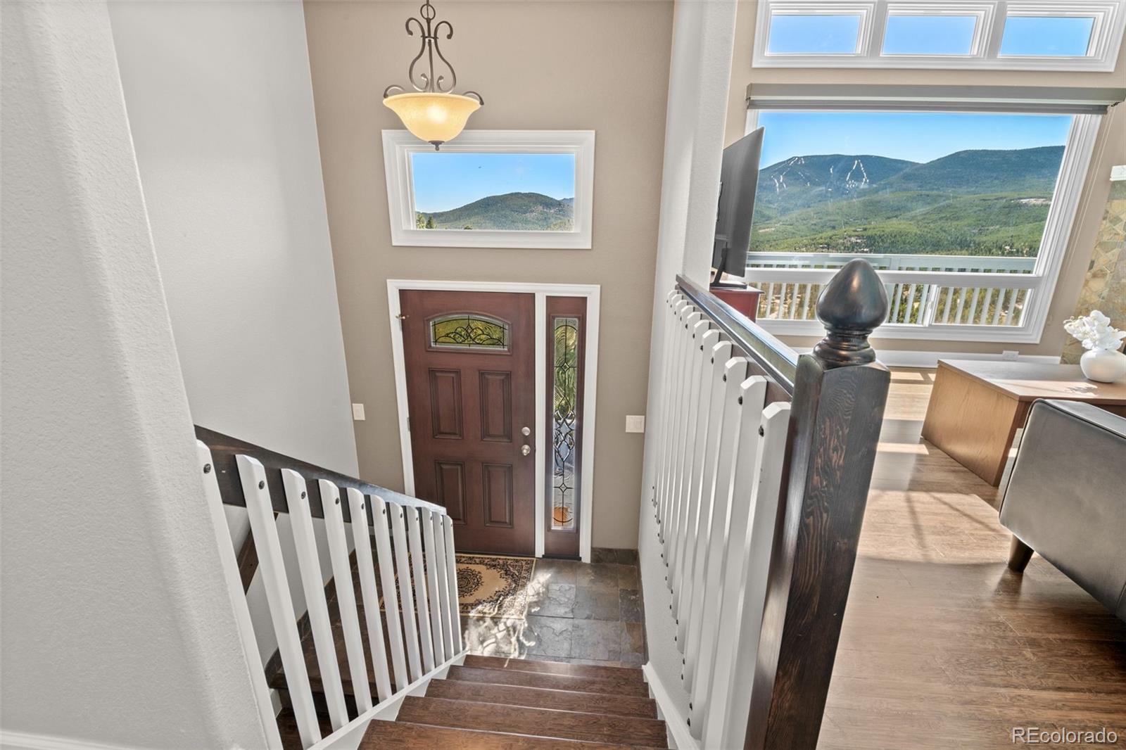 33633 Elk Run Evergreen, CO 80439 - Photo 3 of 39 a view of a hallway with wooden floor and windows