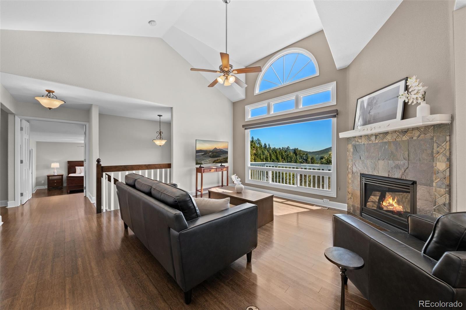 33633 Elk Run Evergreen, CO 80439 - Photo 5 of 39 a living room with furniture a fireplace with wooden floor