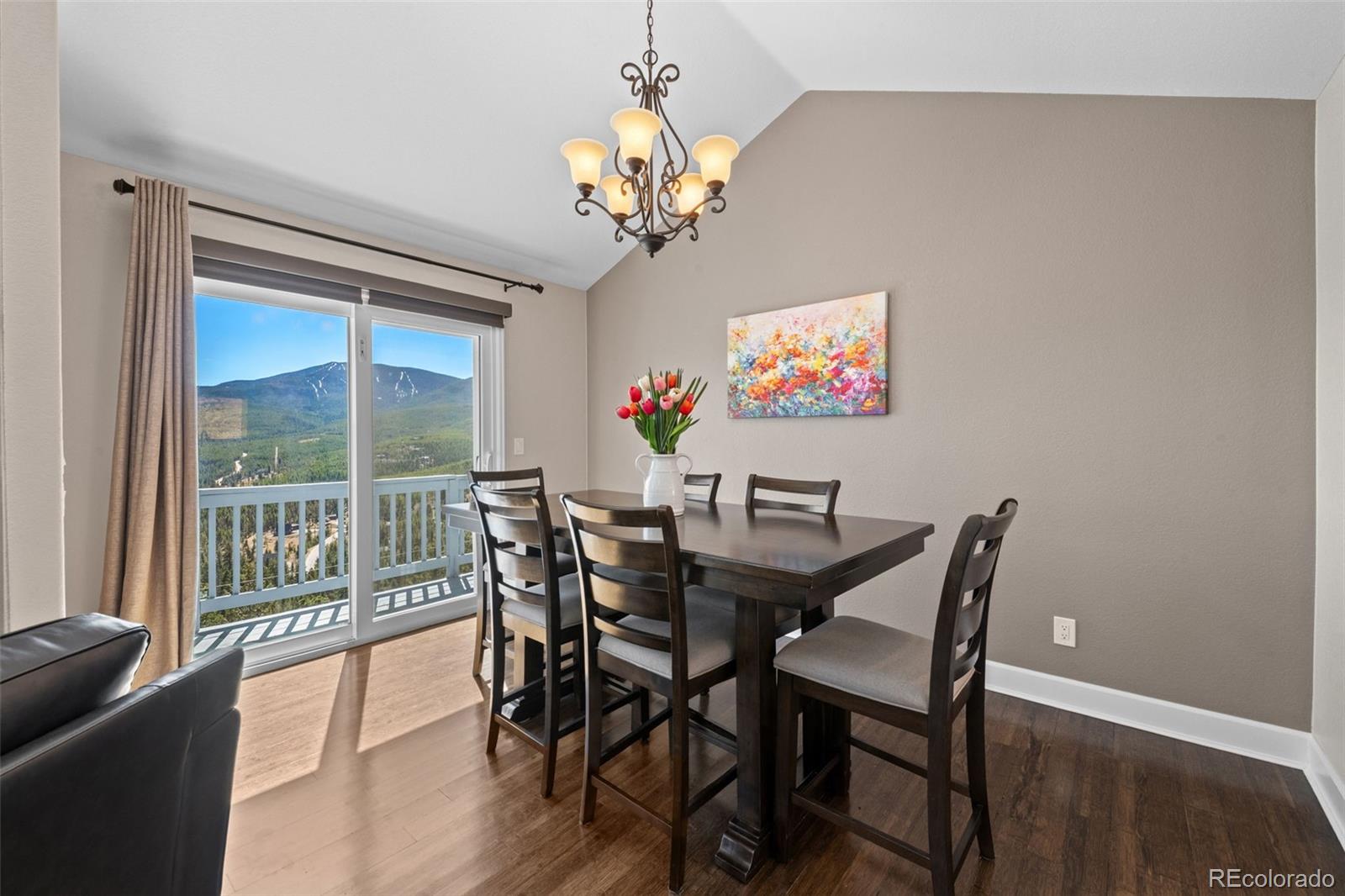 33633 Elk Run Evergreen, CO 80439 - Photo 9 of 39 a view of a dining room with furniture a chandelier and wooden floor