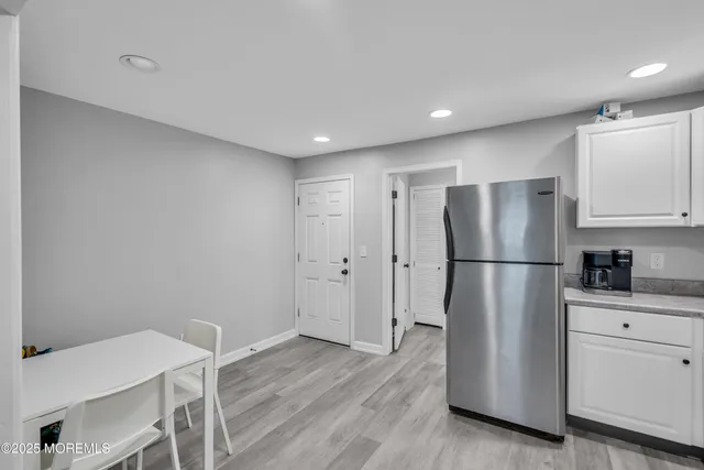 a kitchen with a refrigerator a sink and cabinets
