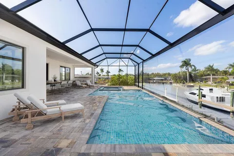 a view of a patio with a table chairs and a fireplace