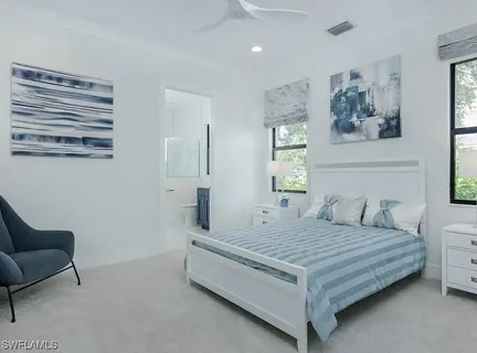 a bedroom with a bed couch and window