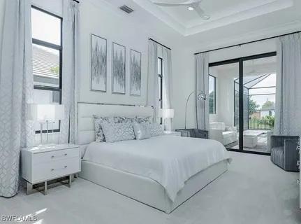 a bedroom with a bed and a large window