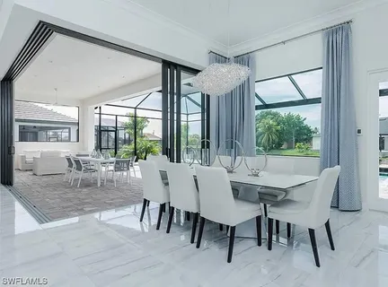 a view of a dining room with furniture large windows and wooden floor