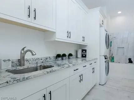 a kitchen with stainless steel appliances granite countertop a sink a stove and cabinets