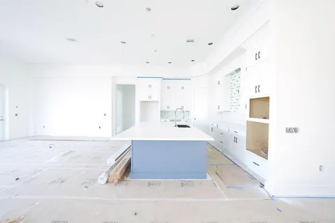 a spacious bathroom with a tub sink and mirror