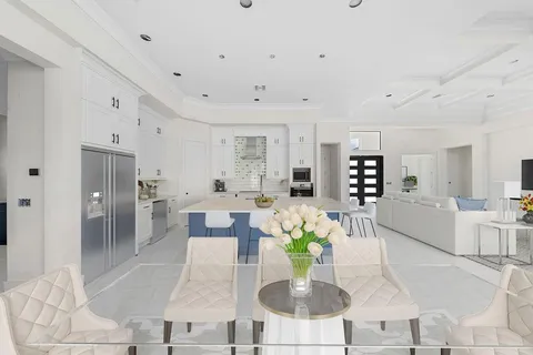 a living room with furniture potted plant and a table