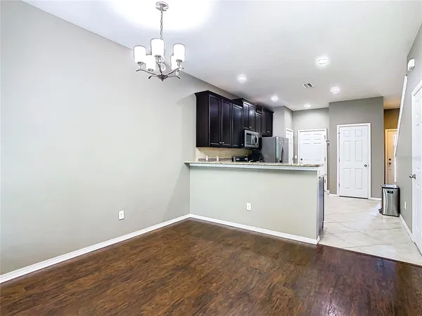 a kitchen with stainless steel appliances granite countertop a refrigerator sink and cabinets