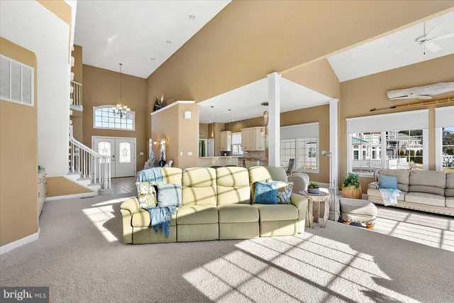 a view of a dining room with furniture and a chandelier