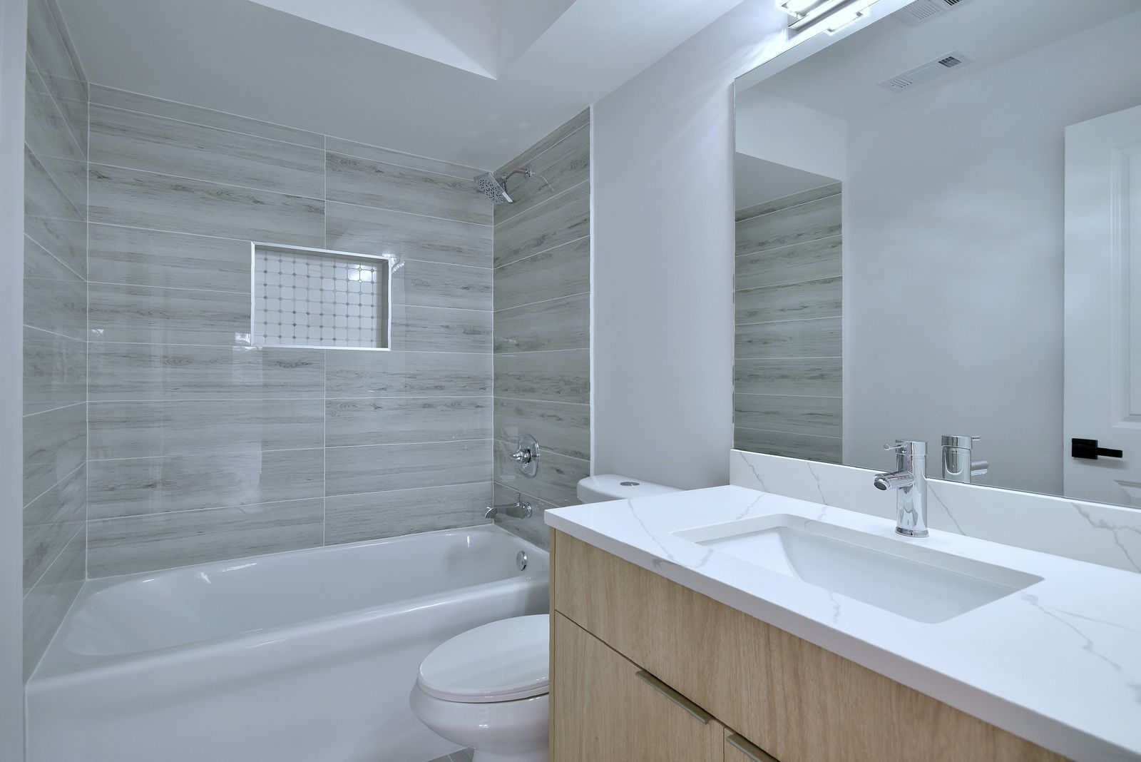7314 Randolph Street, Unit 3G Forest Park, IL 60130 - Photo 12 of 15 a bathroom with a granite countertop bathtub shower sink vanity and toilet