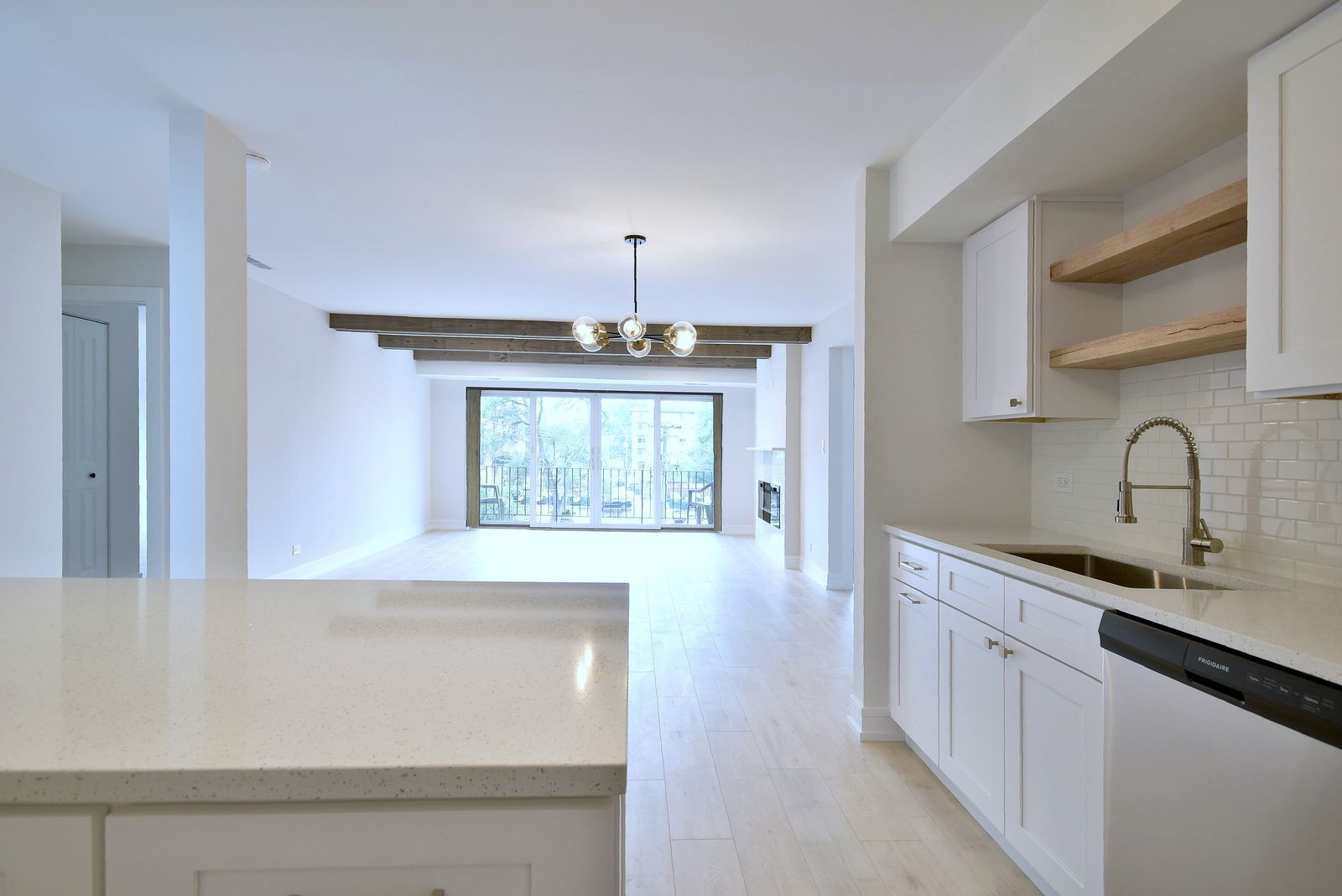 7314 Randolph Street, Unit 3G Forest Park, IL 60130 - Photo 13 of 15 a view of a kitchen with a sink wooden cabinets and a window