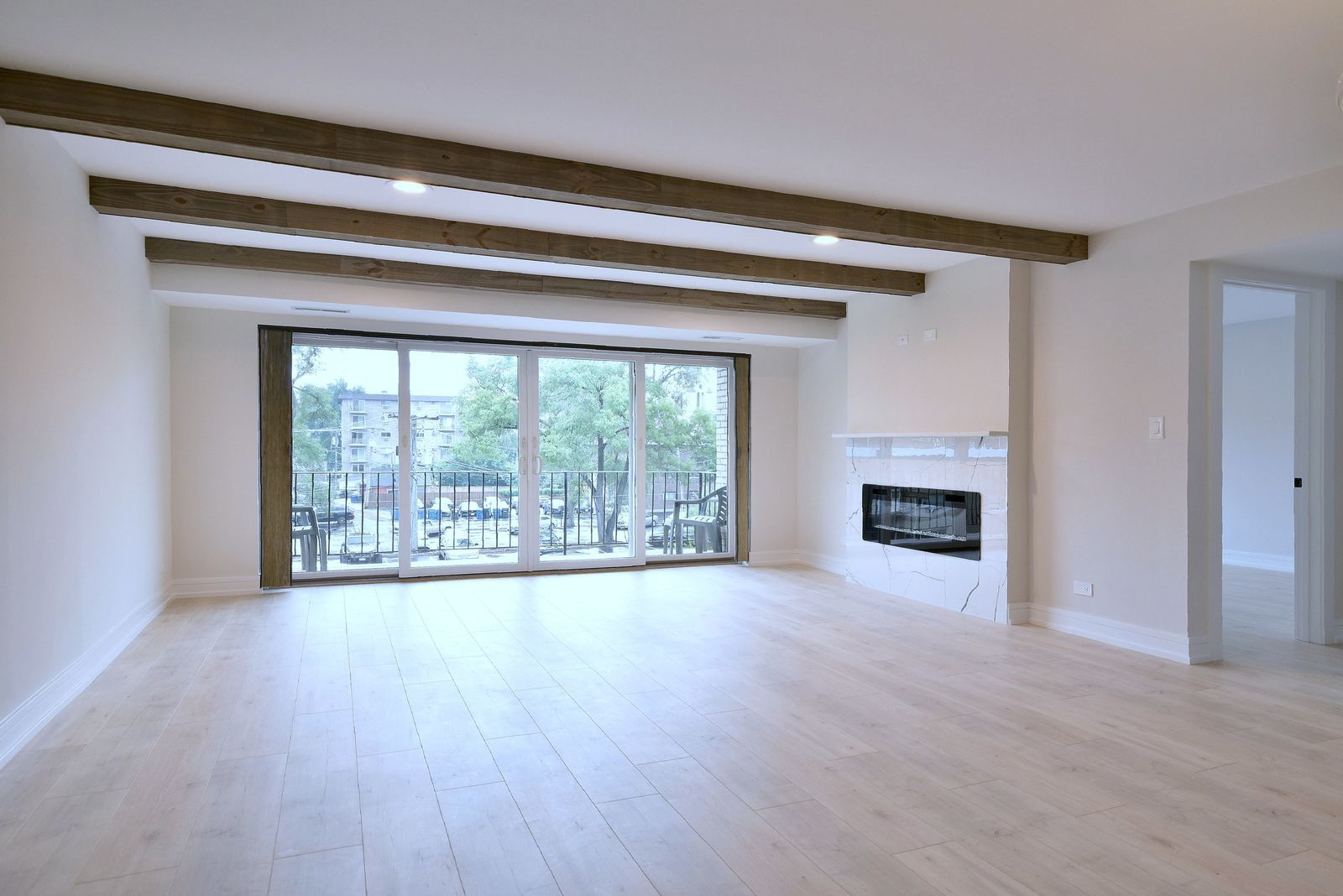 7314 Randolph Street, Unit 3G Forest Park, IL 60130 - Photo 5 of 15 a view of an empty room with wooden floor and a window