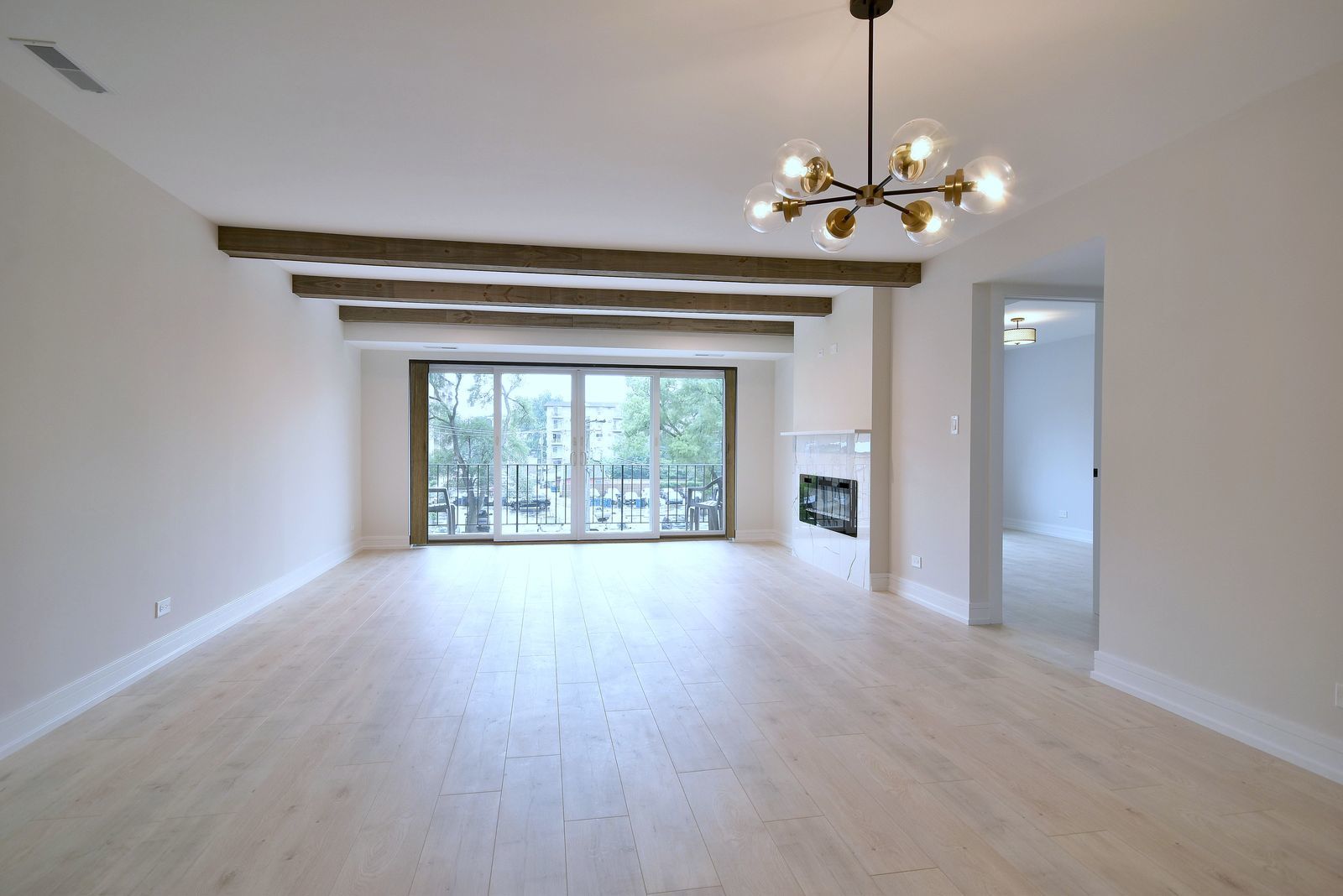 7314 Randolph Street, Unit 3G Forest Park, IL 60130 - Photo 6 of 15 a view of an empty room with a chandelier fan and a window