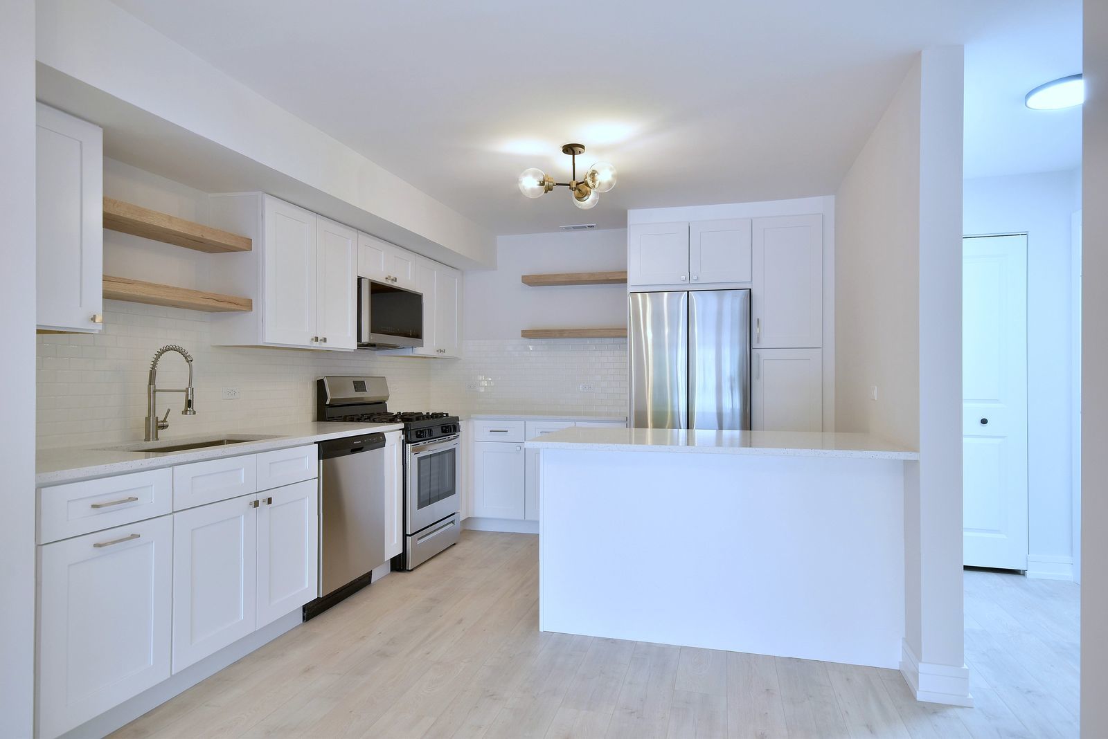 7314 Randolph Street, Unit 3G Forest Park, IL 60130 - Photo 8 of 15 a kitchen with cabinets a sink and stainless steel appliances