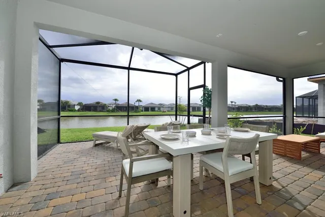 a living room with couches and a table with garden view